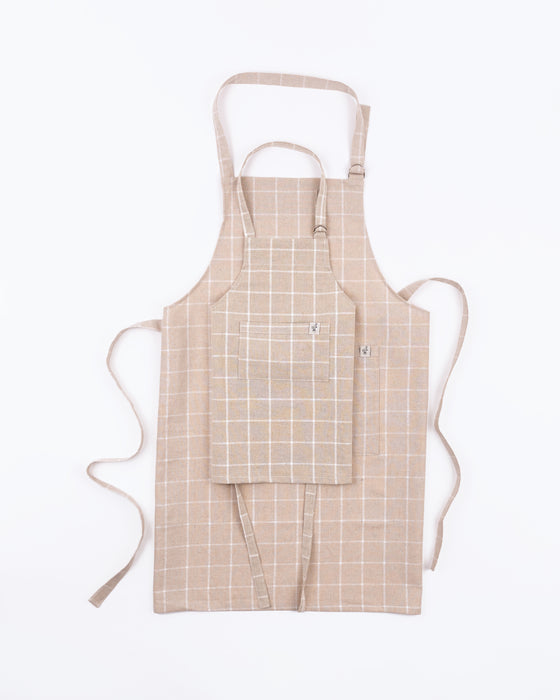 https://www.fawnandforest.com/cdn/shop/products/Milton-and-Goose-Adult-Apron-Childs-Apron-Tan-Stacked_561x700.jpg?v=1669397201